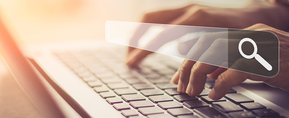Hands typing on a laptop