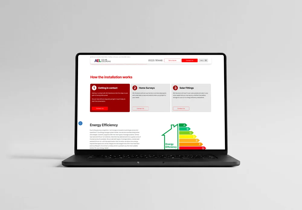 AEL Solar 'Sustainable Solar Energy Solutions' homepage shown on a MacBook on a wooden table