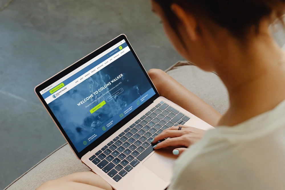 Woman viewing the Collins Walker homepage on a laptop