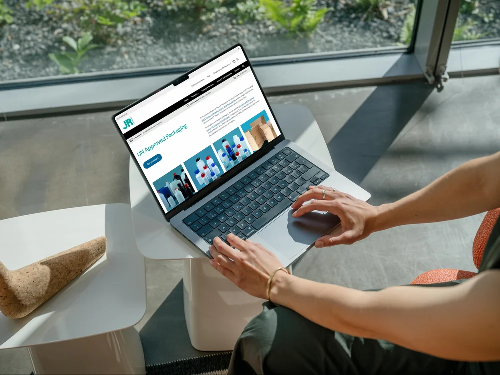 Woman viewing the JR Packaging website on a MacBook
