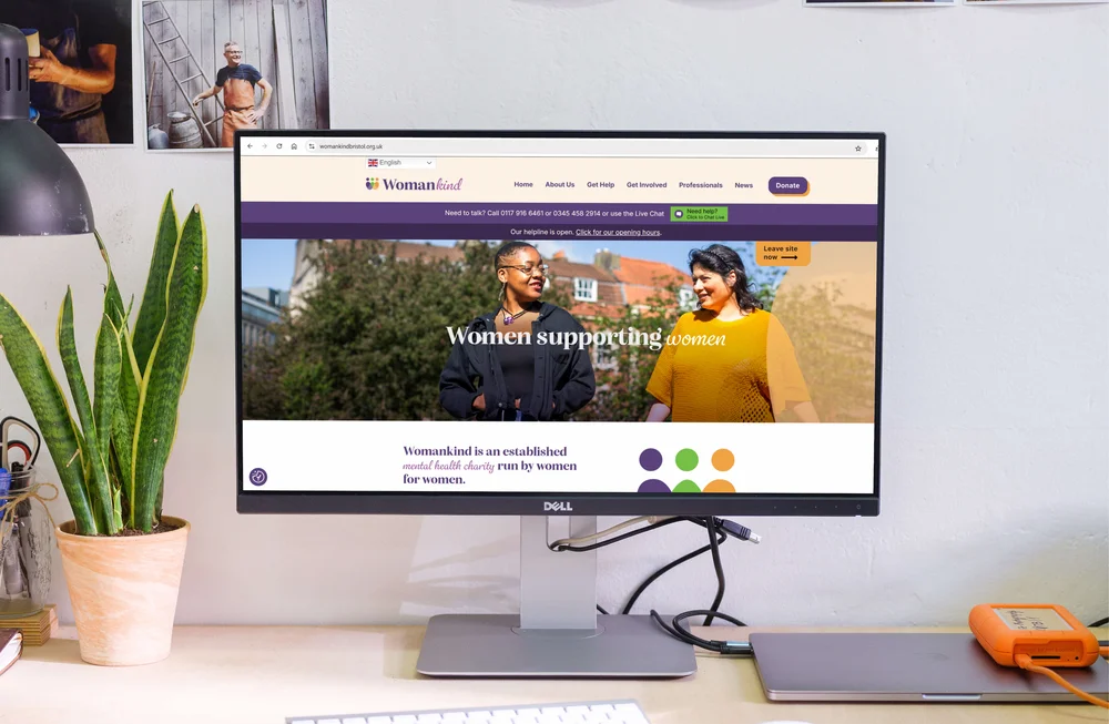 Womankind Bristol 'Women supporting women' homepage shown on a desktop monitor